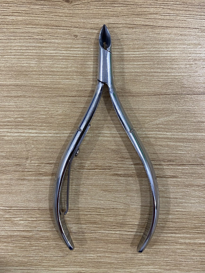 ElisNail semi-round lap joint cuticle nipper, full tool on a wooden bench