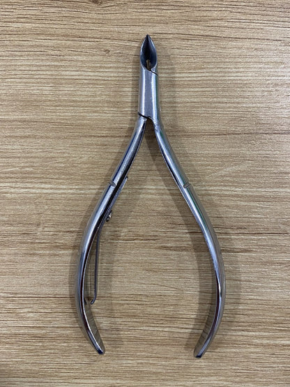 ElisNail semi-round lap joint cuticle nipper, full tool on a wooden bench