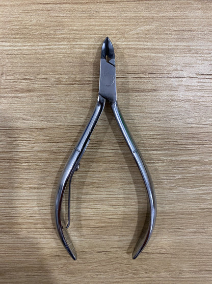 ElisNail square box joint cuticle nipper, full tool on a wooden bench