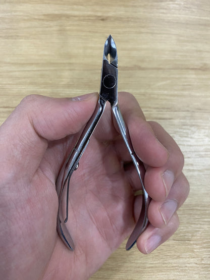 ElisNail square box joint cuticle nipper held in a hand to show its size